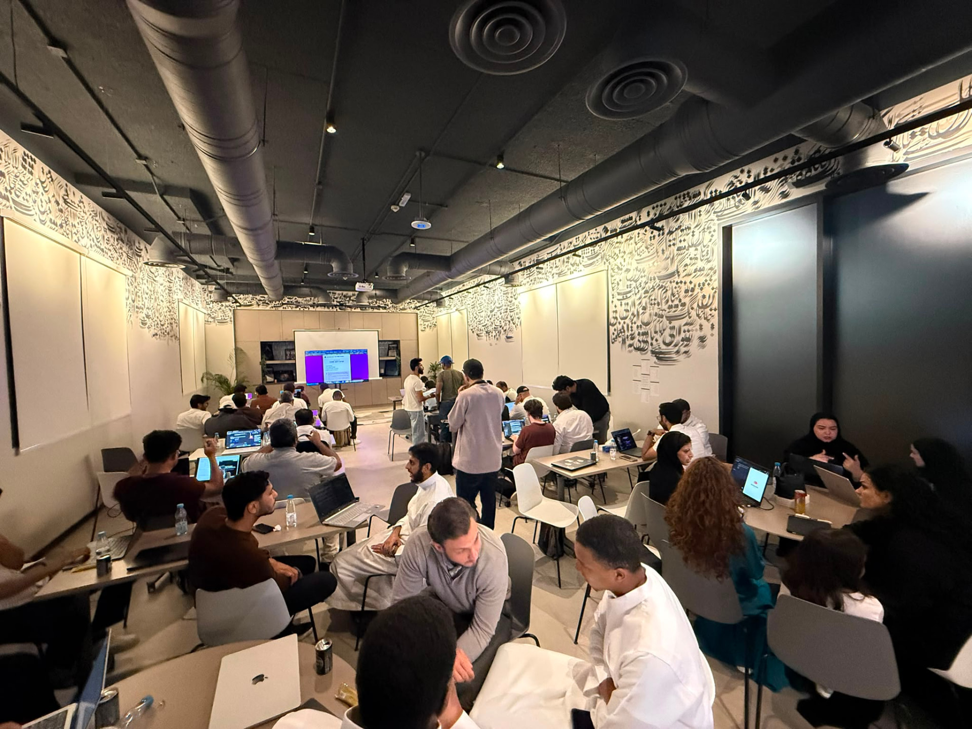 A full room of builders mid-hackathon
